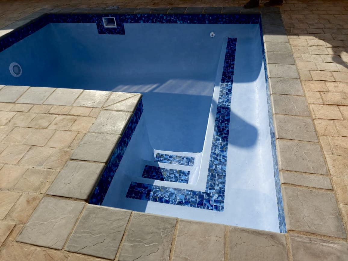 Pristine new pool with mosaic trim